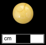 18QU124 - Machine made glass marble, single color yellow opaque.  These marbles occasionally have minor swirling patterns due to incomplete mixing of the glass.  Introduced in early 1920s and continuing production to present (Randall and Webb 1988:34-35) - click image to see larger view.